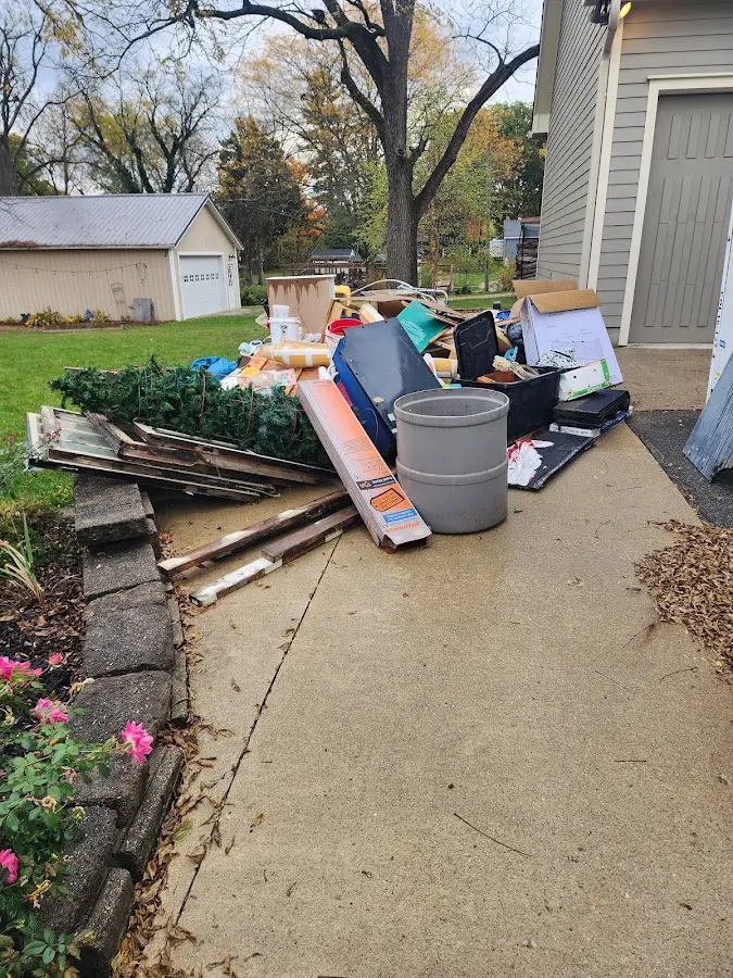 Dumpster being loaded with debris for Roofing Dumpster Rental in Richmond